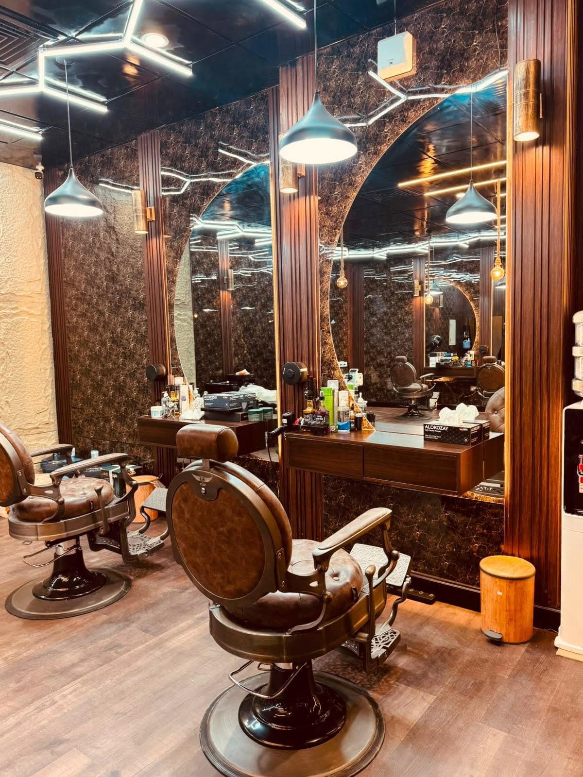 Leather barber chairs facing arched mirrors